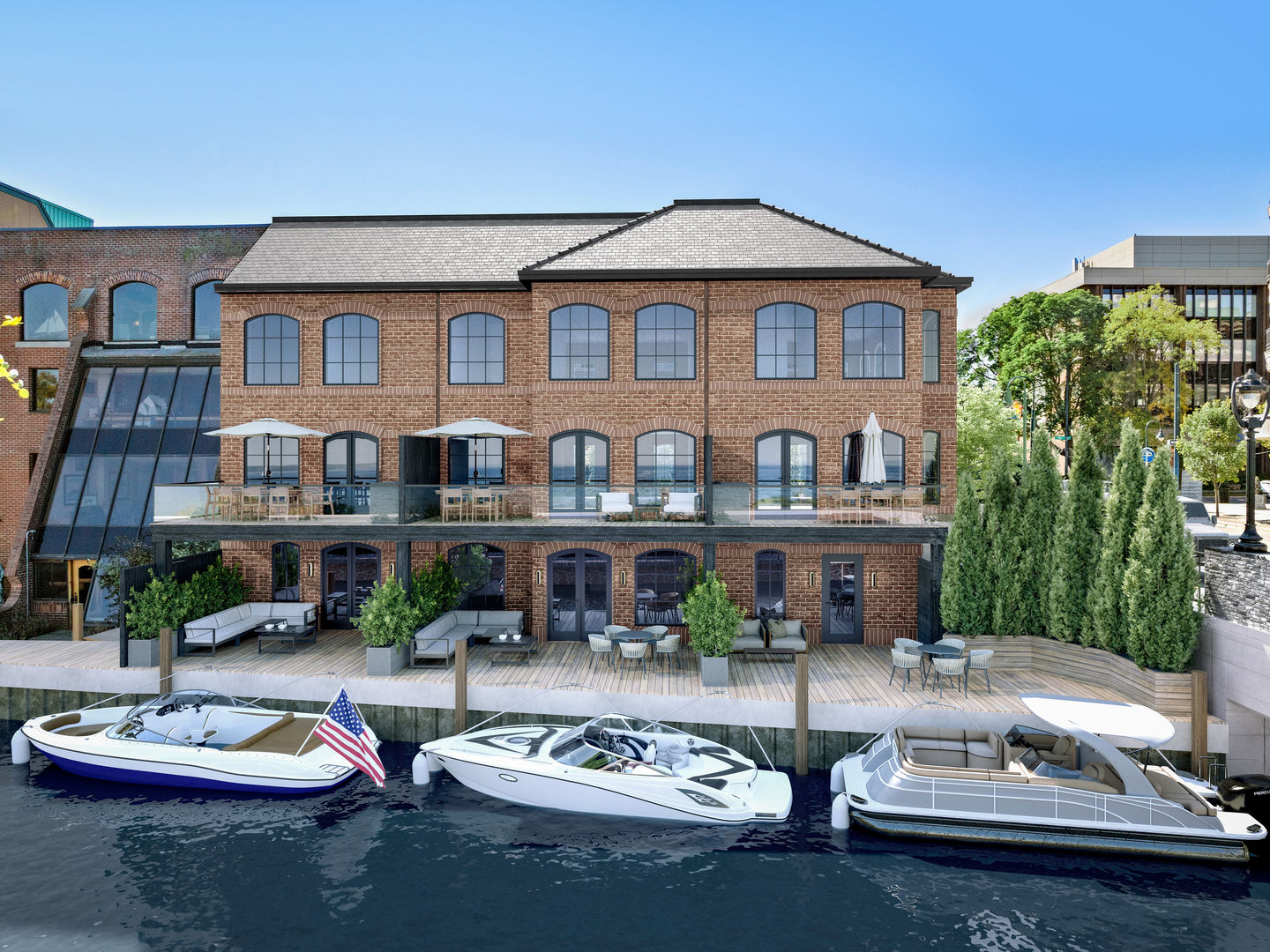 Brick waterfront mixed-use building with boats moored at its dock