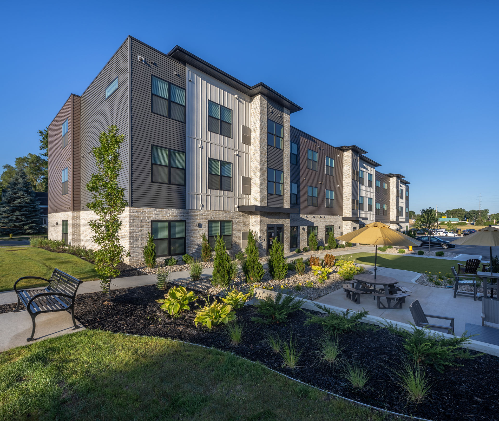 Three-storey multifamily residential building with landscaped grounds